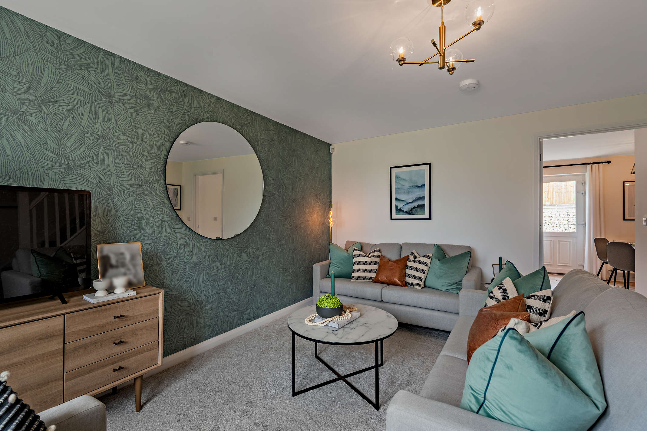 Living room with green decorative wall paper and modern interior located at The Spires in Great Gonerby. A development by Longhurst Group